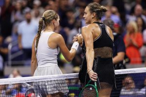 Polina Iatcenko, of Russia, left, and Aryna Sabalenka, of Belarus, meet at the net