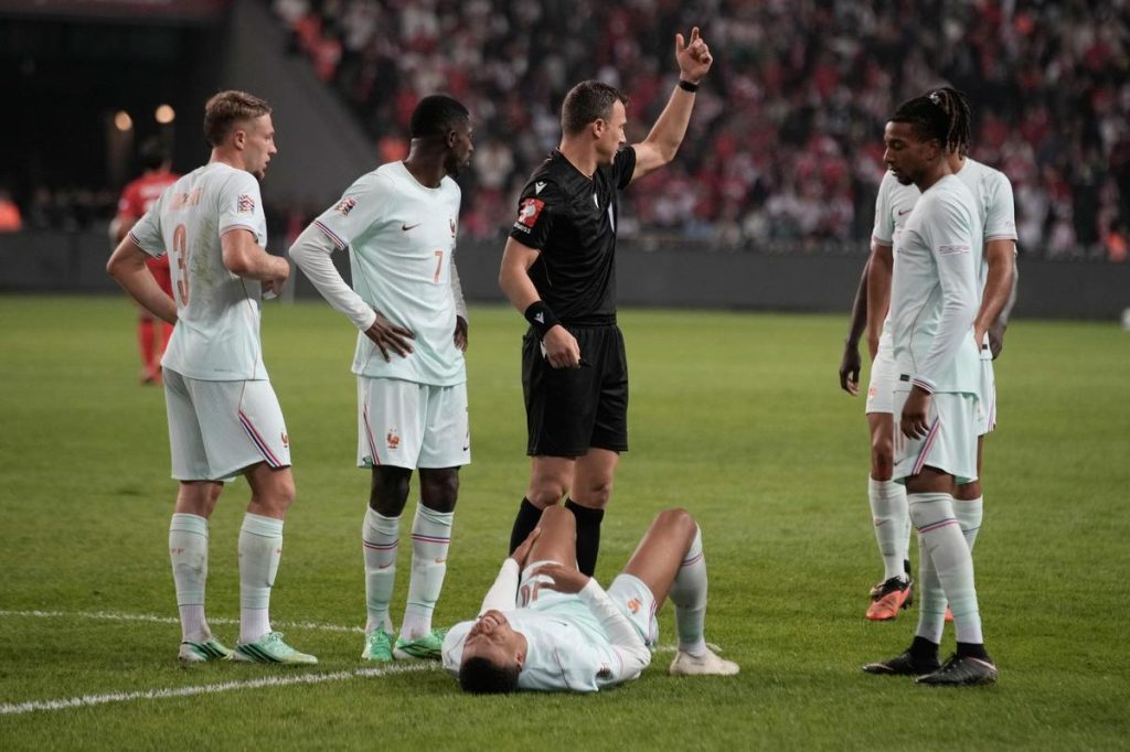 France's Kylian Mbappe lies on the ground after he scored and injured himself during the UEFA